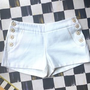 White cotton shorts with side buttons